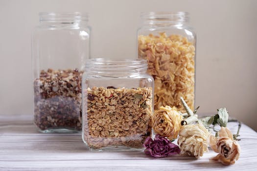Dry Cereals in Clear Glass Jars Beside Dried Flowers