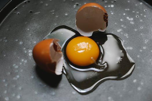 Cracked egg on pan for cooking breakfast