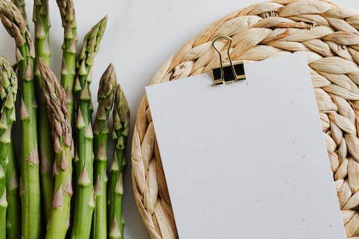 Paper sheets fastened by paper clip and asparagus