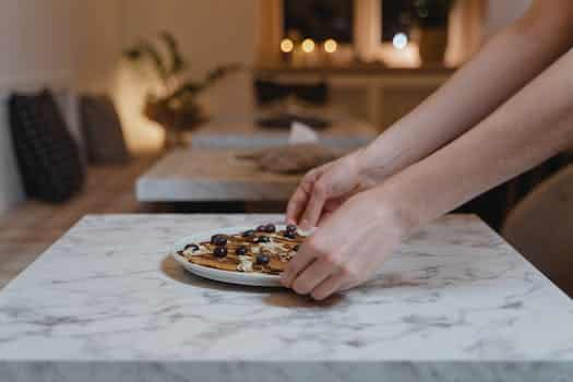 A Person Holding a Ceramic Plate with Food