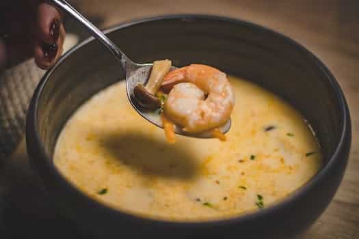 Bowl of Shrimp Soup on Brown Wooden Surface