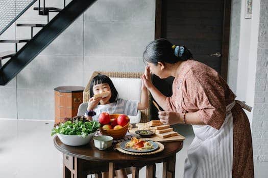 Happy grandmother with little girl during lunch