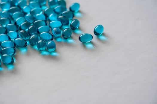 Blue Gel Capsules On White Surface