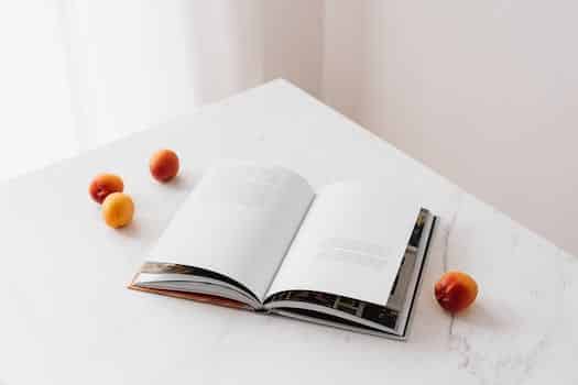 Opened book on table with fresh apricots